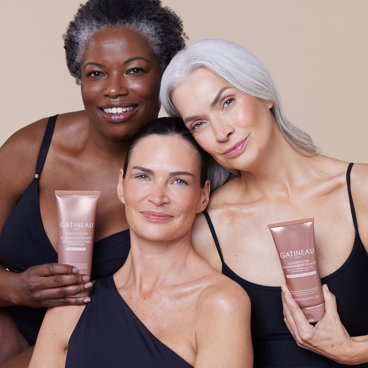 Three women holding Gatineau skincare products against a beige background