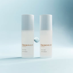 Two bottles of Omorovicza Daily Dew on a gradient blue background