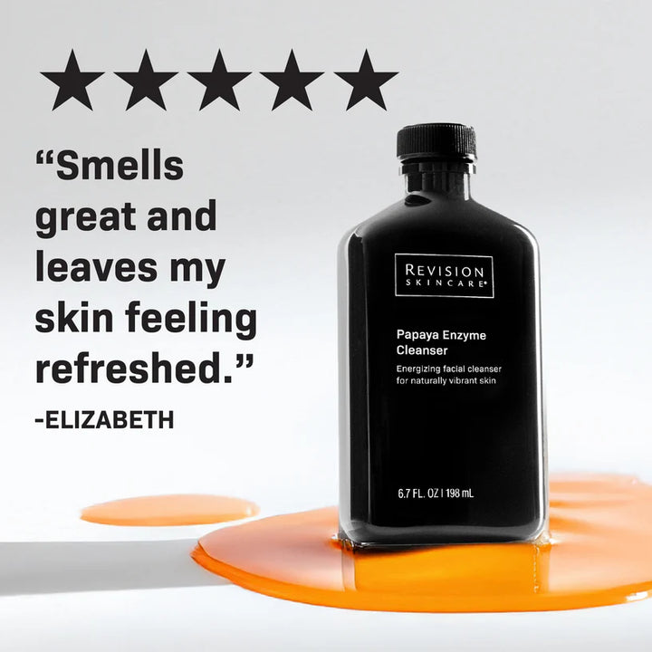 Black bottle of Revision Skincare Papaya Enzyme Cleanser with a five-star rating and customer review on a gray background.