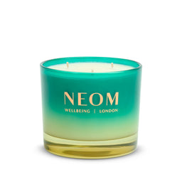 Neom candle with gradient green and yellow design on a white background