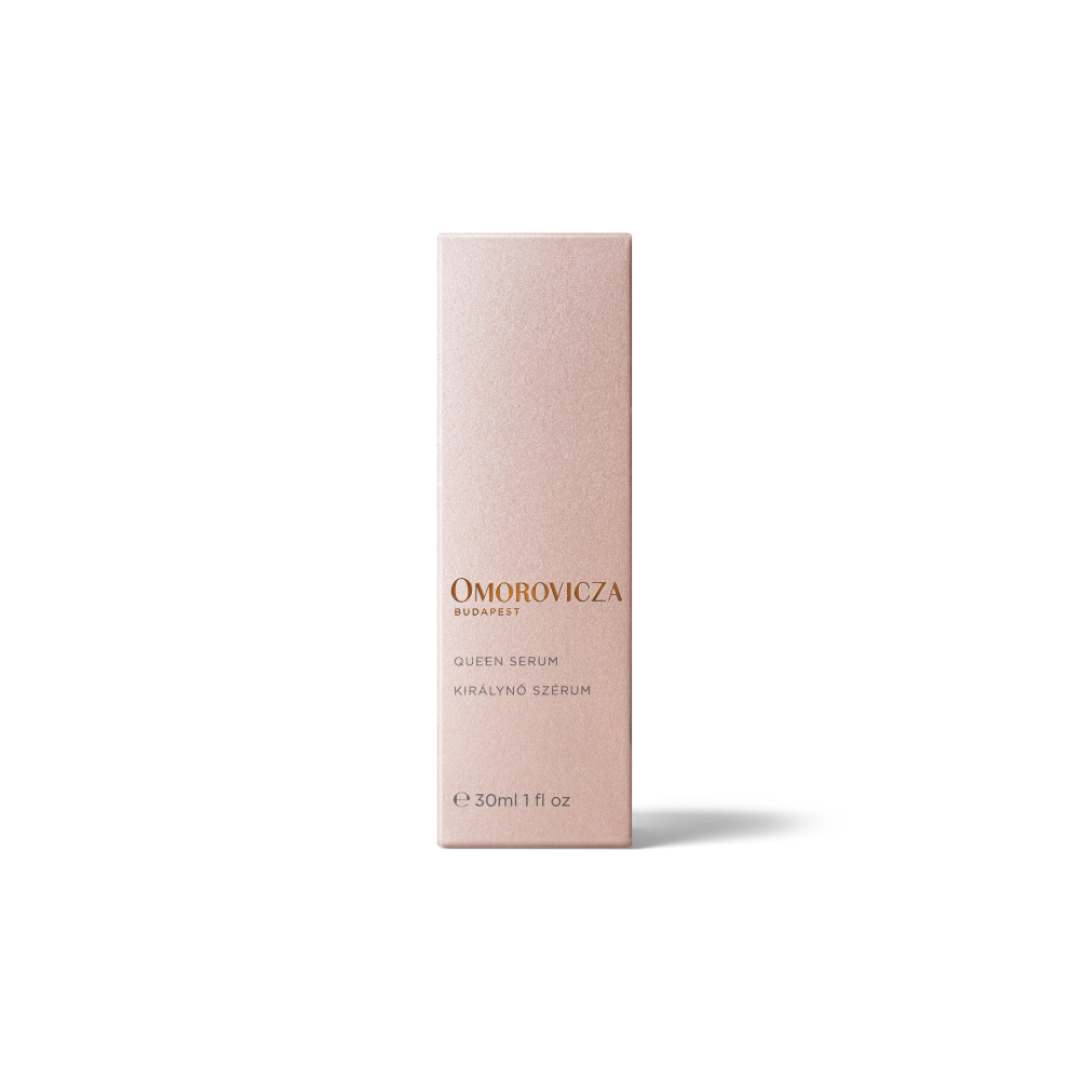 A tall, slim rectangular box for Omorovicza Queen Serum in Keralino Serum, shown in a soft blush pink color with gold lettering, set against a plain white background.