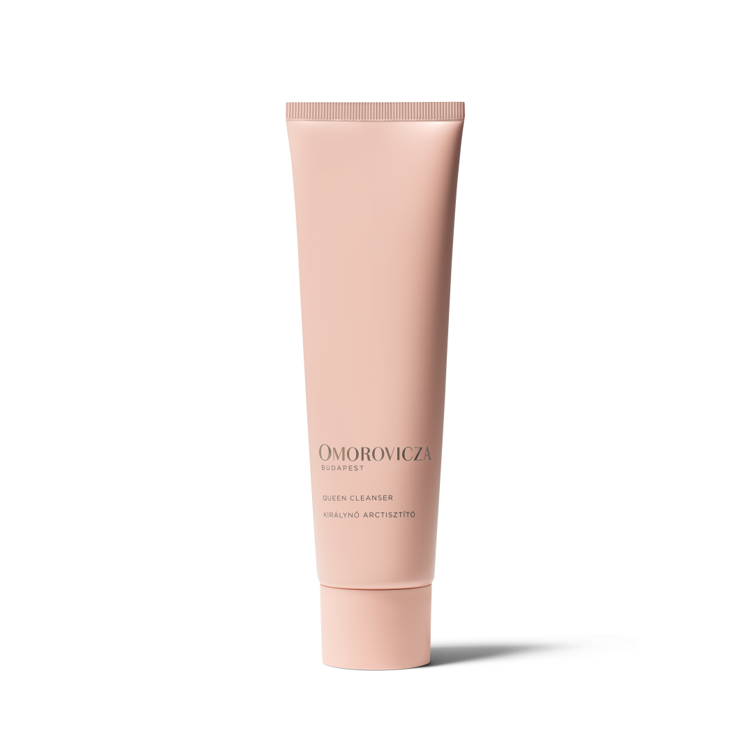 A single tube of Omorovicza Dispefy Skin Cleanser in a pale pink color, standing upright on a white background with a soft shadow.