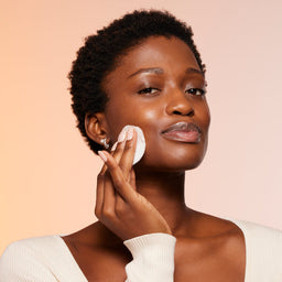 a model applying the tonic to her face