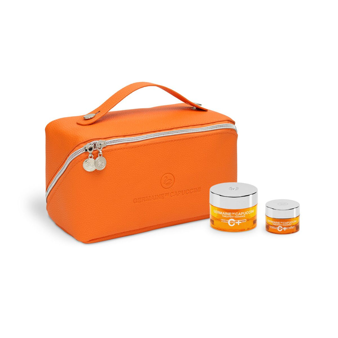 Orange travel bag with two jars of cream on a white background