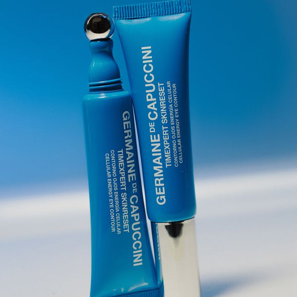 Two blue cosmetic tubes with silver caps on a gradient blue background