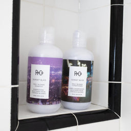 two bottles of R+Co Sunset Blvd in a shower setting