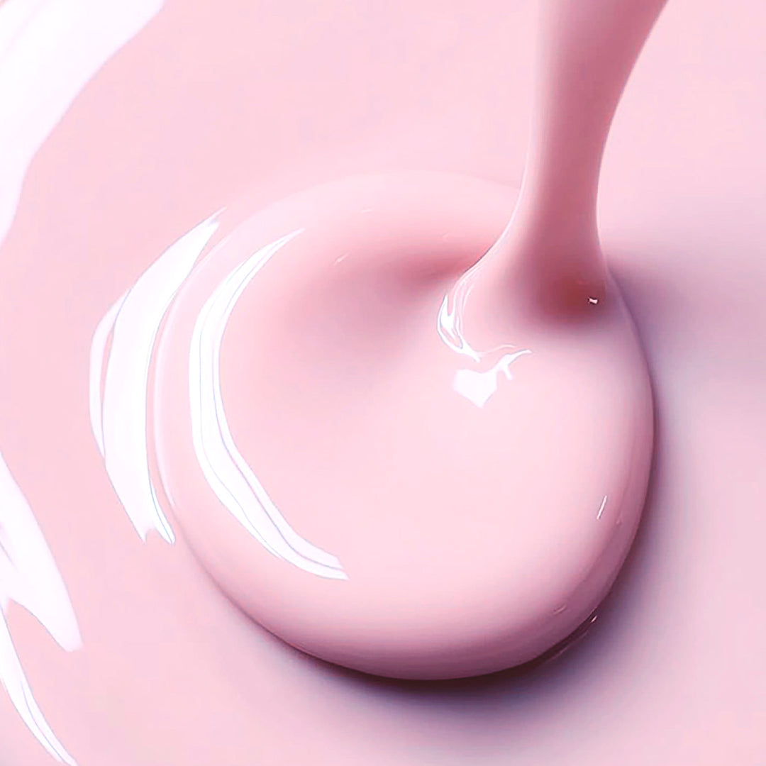 Close-up of pink liquid being poured with a swirling motion.