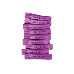 Purple 'Vida Glow' packets stacked on a white background