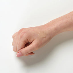 Ultrasun Sports Spray SPF 30 150ml being used on hand