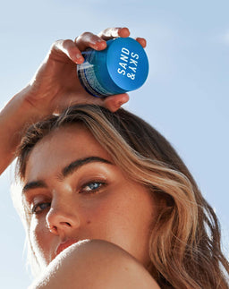 Model holding Sand & Sky Tasmanian Spring Water Hydration Boost Cream above her head
