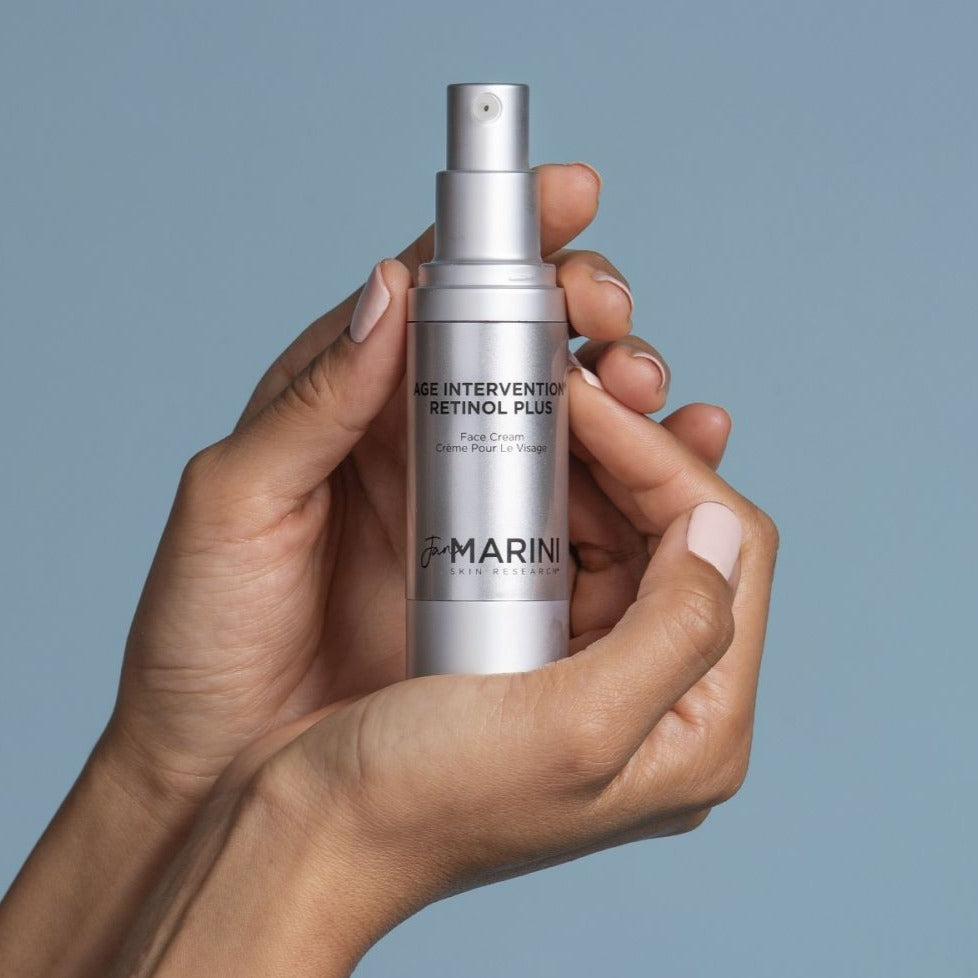 a model holding the bottle in the palm of their hands