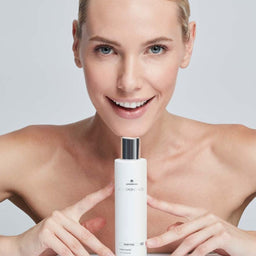 Model holding a bottle of ALLSKIN MED Cleansing Gel under her chin