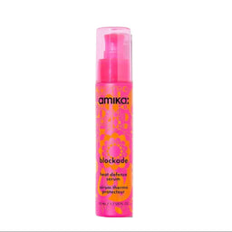 Pink bottle of amika blockade heat defense serum on a white background