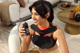 Woman Smiling Holding Controller for the Red Light Neck and Chest Mask