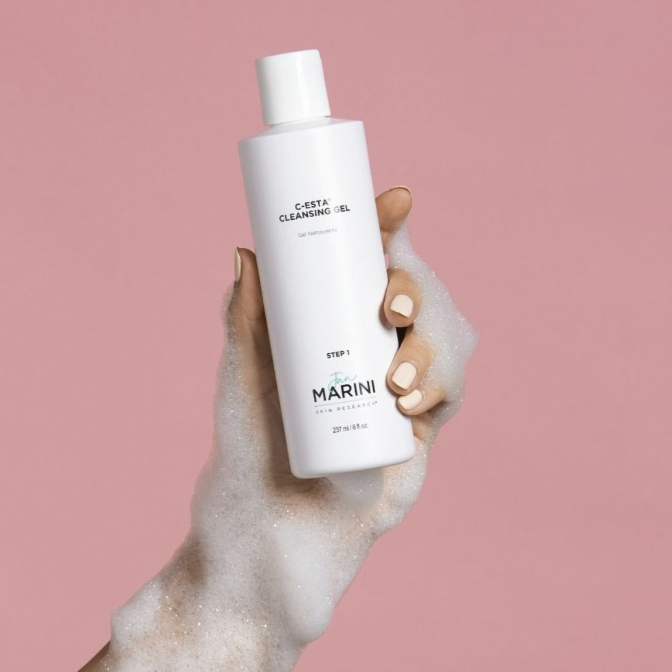 a bottle being held up by a soap covered hand