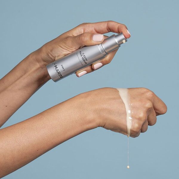 the serum being poured onto a and and wrist 