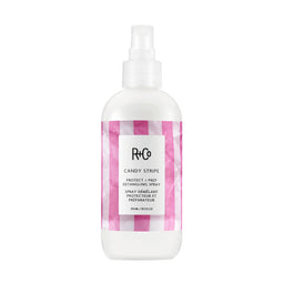 R+Co Candy Stripe hair spray bottle with pink and white checkered design on a white background