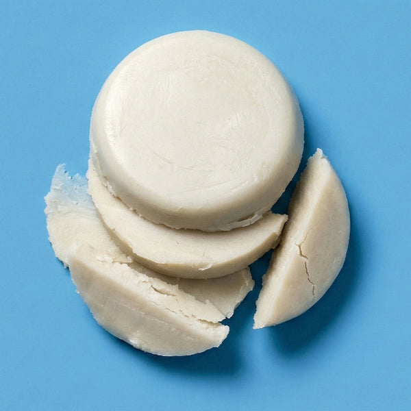 Stack of white macaron cookies on a blue background