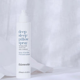 Bottle of deep sleep pillow spray with packaging on a white background