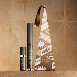 Skincare products and packaging with a decorative pattern on a brown background