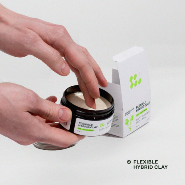 Person opening a jar of flexible hybrid clay with a box next to it on a white background
