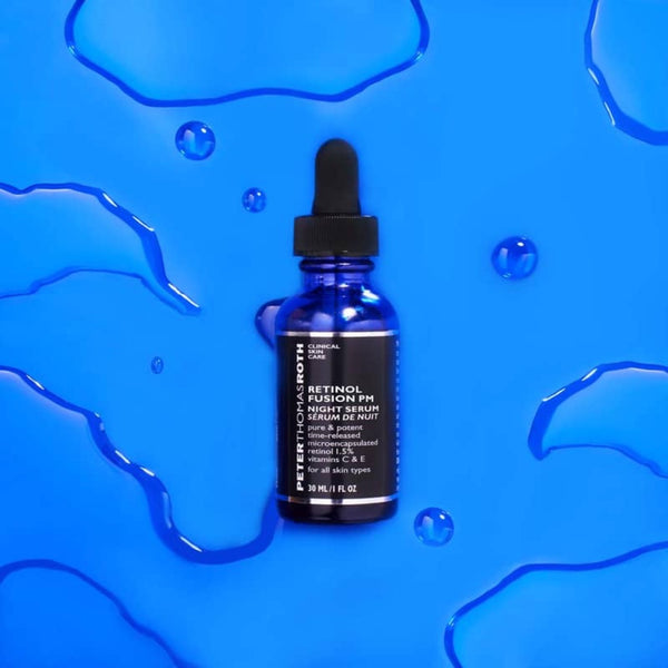 Peter Thomas Roth Retinol Fusion PM Night Serum 1 on a watery blue surface 