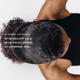 Top-down view of a person wearing a black hairpiece or wig, showing the dark brown to black textured hair against a white background with promotional text on the left.