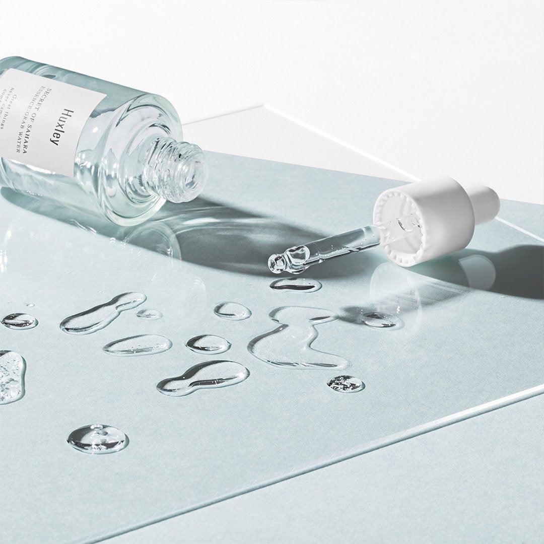 Huxley Essence; Grab Water bottle tipped over its its pipette pouring out