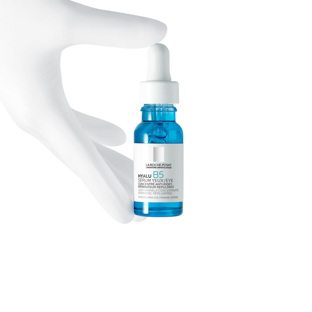 A hand holding a bottle of La Roche-Posay Hyalu B5 Eye Serum