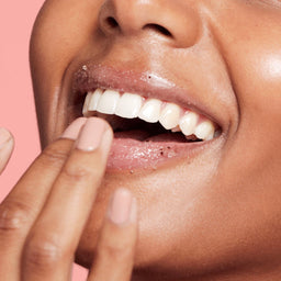 a women applying the scrub to her lips